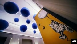 Giant balloons hang from the ceiling leading to the "Winnie-the-Pooh: Exploring a Classic" exhibit at the Museum of Fine Arts in Boston, Sept. 13, 2018.