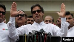Cricket star-turned-politician Imran Khan, chairman of Pakistan Tehreek-e-Insaf (PTI), speaks to members of media after casting his vote at a polling station during the general election in Islamabad, Pakistan, July 25, 2018. On Friday he was declared the winner of the parliamentary election.