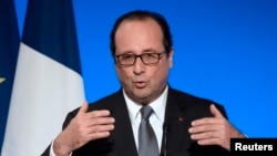 FILE - French President Francois Hollande delivers a speech at the Elysee Palace in Paris, July 23, 2014. 