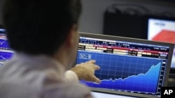 A Portuguese broker follows the Portuguese government's bond auction Wednesday, April 20, 2011 in a trading room in Lisbon