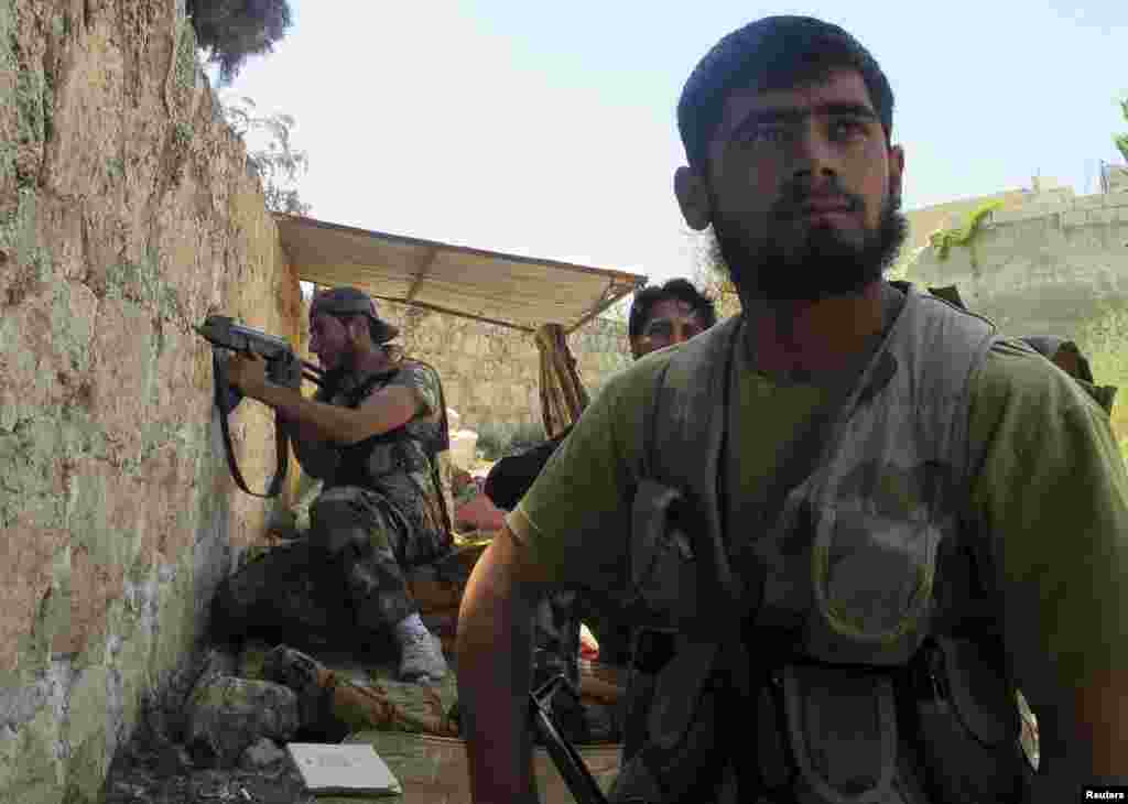 Free Syrian Army fighters take up firing positions in the Khan al-Assal area, near Aleppo, April 27, 2013.