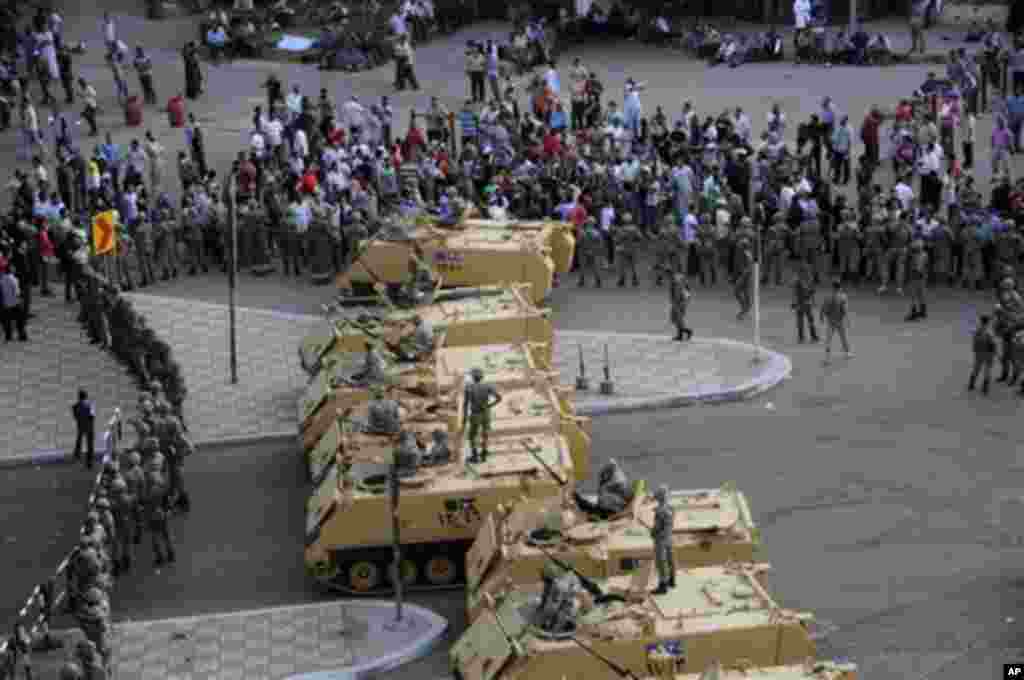 Armored Egyptian military vehicles block the road outside of the Ministry of Defense in Cairo, Egypt, Friday, May 4, 2012. Egyptian armed forces and protesters clashed in Cairo on Friday, with troops firing water cannons and tear gas at demonstrators who 
