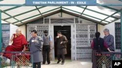 Parliamentarians of Tibet's government-in-exile drink tea and talk during a break from a parliament session in the northern Indian town of Dharamshala, March 21, 2011.