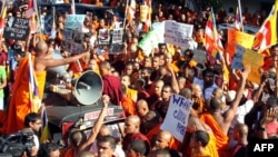 Sri Lankan Buddhist monks shout slogans and hold placards as they stage a protest rally outside the Bangladesh High Commission in Colombo, October 4, 2012.