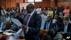 Members of the public listen as the High Court in Kenya begins hearing arguments in a case challenging parts of the penal code seen as targeting the lesbian, gay, bisexual and transgender communities, at the High Court in Nairobi, Kenya, Feb. 22, 2018.