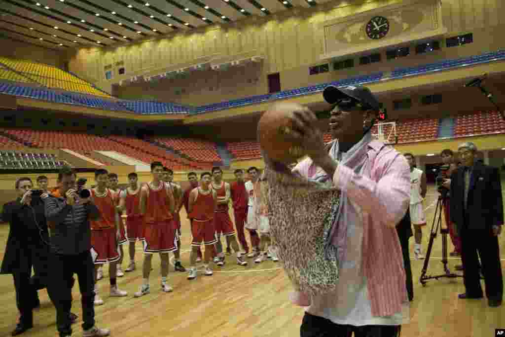 Former NBA basketball star Dennis Rodman takes a jump shot as he gives a demonstration to North Korean basketball players in Pyongyang, North Korea, Dec. 20, 2013. 