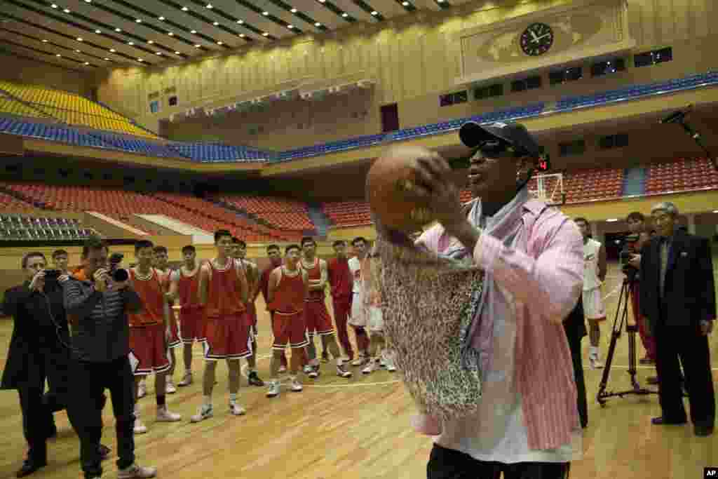 Former NBA basketball star Dennis Rodman takes a jump shot as he gives a demonstration to North Korean basketball players in Pyongyang, North Korea, Dec. 20, 2013.