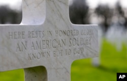 FILE - A gravestone marker for an unknown American soldier sits in the rows of crosses at the Meuse-Argonne American cemetery in Romagne-sous-Montfaucon, France, March 24, 2017.