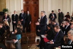 FILE - CNN reporter Jim Acosta asks a question during a news conference held by U.S. President Donald Trump at the White House in Washington, Feb. 16, 2017.