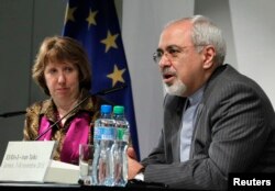 EU foreign policy chief Catherine Ashton listens as Iranian Foreign Minister Mohammad Javad Zarif speaks during a news conference at the end of the Iranian nuclear talks in Geneva, Switzerland, Nov. 10, 2013.