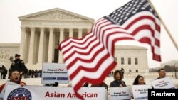 Asian-American demonstrators protest outside the Supreme Court as the affirmative action in university admissions case was being heard by the court in Washington, December 9, 2015. REUTERS/Kevin Lamarque 