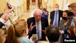 FILE - Senator Bernie Sanders (I-VT) speaks to reporters at the U.S. Capitol building on Capitol Hill in Washington, Sept. 30, 2021.