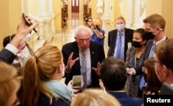FILE - Senator Bernie Sanders (I-VT) speaks to reporters at the U.S. Capitol building on Capitol Hill in Washington, Sept. 30, 2021.