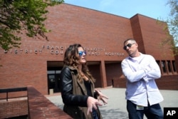 Pat Cronin, right, a director at the Northeast Addictions Treatment Center in Quincy, and Lizabeth Loud, 32, of Randolph, Mass., speak about their experiences of being involuntarily committed for substance abuse treatment, outside District Court in Quincy, Mass., May 7, 2018.