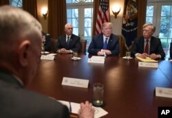 U.S. President Donald Trump, second from right, speaks in the Cabinet Room of the White House in Washington, April 9, 2018, at the start of a meeting with military and national security leaders.