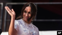 FILE - Meghan Markle, Duchess of Sussex, salutes during the Global Citizen festival, Sept. 25, 2021 in New York.