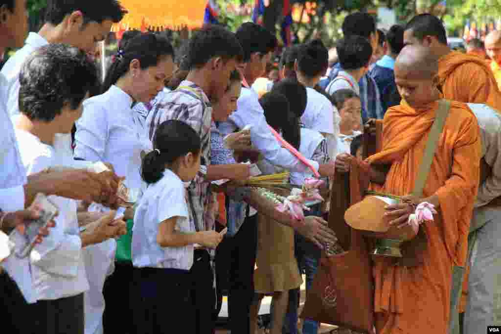 ពុទ្ធបរិស័ទ ដាក់បាត្រ នៅក្នុងការប្រារព្ធពីធីបុណ្យពិសាខបូជា នៅភ្នំឧត្តុង្គ ក្នុងខេត្តកណ្តាល នៅថ្ងៃទី១០ ខែឧសភា ឆ្នាំ២០១៧។ (ហ៊ាន សុជាតា/VOA)