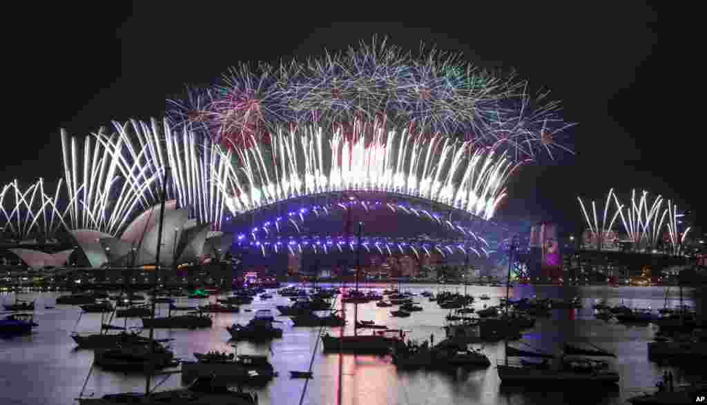 Fireworks explode over the Sydney Opera House and Harbor Bridge as New Year&#39;s celebrations begin in Sydney, Australia.
