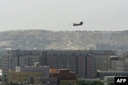 A US military helicopter is pictured flying above the US embassy in Kabul on August 15, 2021.