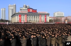 North Koreans gather at Kim Il Sung Square, following their leader Kim Jong Un's new year address in Pyongyang, North Korea, Tuesday, Jan. 5, 2016.