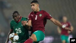 Morocco's Adam Masina, right, kicks the ball as he defends against Malawi's Stain Davie, during the African Cup of Nations 2022 round of 16 soccer match between Morocco and Malawi at the Ahmadou Ahidjo stadium in Yaounde, Cameroon, Jan. 25, 2022. 