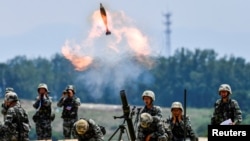 FILE - Soldiers of the Chinese People's Liberation Army fire a mortar during an exercise in Anhui province, China, May 22, 2021.