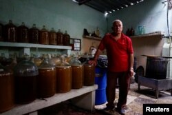 Orestes Estevez memperlihatkan produksi minuman anggur di rumahnya di Havana, Kuba, 16 Mei 2018.