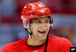 Russia forward Alex Ovechkin laughs with teammates during a training session at the 2014 Winter Olympics, Feb. 10, 2014, in Sochi, Russia.