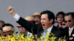 FILE - Taiwan's President Ma Ying-jeou cheers with the audience during National Day celebrations in front of the Presidential Office in Taipei, Taiwan.