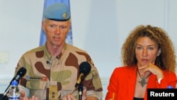 Major General Robert Mood (L), chief of the UN Supervision Mission in Syria (UNSMIS), addresses a news conference in Damascus, next to his spokeswoman Sawsan Ghoshe, July 5, 2012. 
