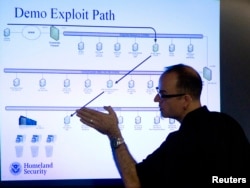 FILE - Mark Fabro, a training consultant working with the U.S. Department of Homeland Security, explains how systems can be exploited at a cybersecurity defense lab at the Idaho National Laboratory in Idaho Falls, Idaho, Sept. 29, 2011.