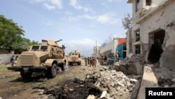 African Union Mission in Somalia (AMISOM) forces secure scene of suicide bombing outside the United Nations compound, Mogadishu, June 19, 2013.