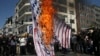 Иранские протестующие сжигают изображение флага США на ежегодном антиизраильском митинге «Аль-Кудс» в честь Дня Иерусалима в Тегеране (архивное фото).