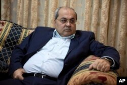 FILE - Arab lawmaker Ahmad Tibi speaks during an interview with the Associated Press at his home in Jerusalem, March 6, 2019.