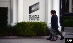 FILE - Pedestrians walk past an exterior wall of Sony Pictures Studios in Los Angeles, California, Dec. 4, 2014. That year, Sony became the victim of a cyber hack by North Korean operatives from the Lazarus Group.
