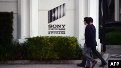 FILE - Pedestrians walk past an exterior wall of Sony Studios in Los Angeles, California, Dec. 4, 2014. That year, Sony became the victim of a cyber hack by North Korean operatives from the Lazarus Group