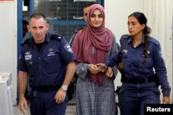 FILE - Turkish citizen, Ebru Ozkan, who was arrested at an Israeli airport last month, is being brought to an Israeli military court, near Migdal, Israel, July 8, 2018.