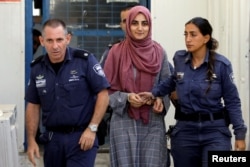 FILE - Turkish citizen, Ebru Ozkan, who was arrested at an Israeli airport last month, is being brought to an Israeli military court, near Migdal, Israel, July 8, 2018.
