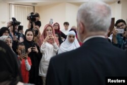 Britain's opposition Labour Party leader, Jeremy Corbyn, meets local people in Finsbury Park Mosque, near the scene of an attack, in London, Britain, June 19, 2017.