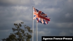 This photograph taken on Dec. 10, 2021, shows the Britain flags wave, in the harbor of Ouistreham, northwestern France. 