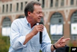 FILE - Montana Gov. Steve Bullock speaks at the Des Moines Register Soapbox during a visit to the Iowa State Fair in Des Moines, Iowa, Aug. 16, 2018.