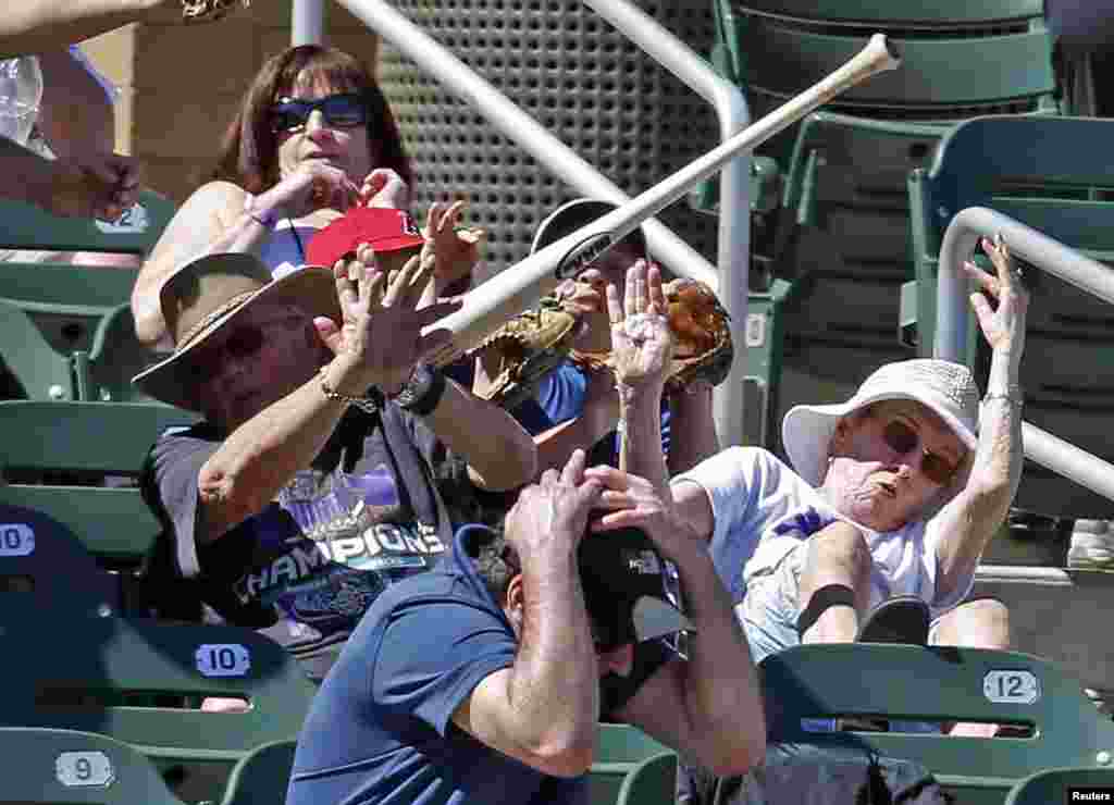 Para penggemar mencoba menghindar setelah pemukul bisbol atlet Matt Duffy (5) dari tim San Francisco Giants terlempar dalam babak ketiga pertandingan melawan Arizona Diamondbacks di Salt River Fields di Talking Stick (23/3). (Foto: Rick Scuteri-USA TODAY Sports)