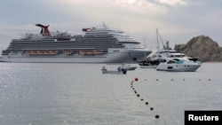 FILE - The Carnival Panorama cruise ship is docked at Melano beach after passengers tested positive for COVID-19 in Cabo San Lucas, Mexico, Dec. 29, 2021.
