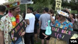 Counter-protester Jesse Belsky (left) came dressed for a luau to mock the white supremacists who carried tiki torches at the Unite the Right rally in Charlottesville, Virginia, last year.