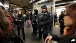 New York City Police Department Transit officers patrol a Times Square subway platform, in New York, March 22, 2016. (AP Photo/Richard Drew)