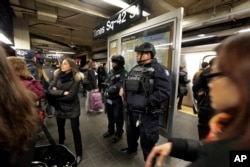 New York City Police Department Transit officers patrol a Times Square subway platform, in New York, March 22, 2016.