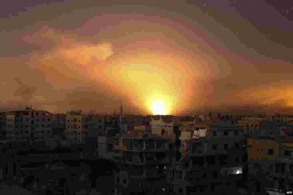 Explosions light the sky following government airstrikes on Arbin, in the rebel enclave of Eastern Ghouta on the outskirts of Damascus, Syria, March 12, 2018.