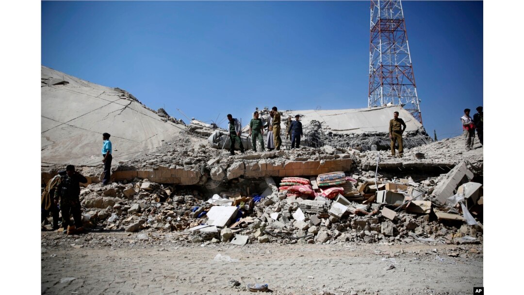 File-Police gather at the site of a Saudi-led airstrike on the police headquarters in Sana'a, Jan. 18, 2016.