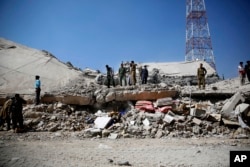 File-Police gather at the site of a Saudi-led airstrike on the police headquarters in Sana'a, Jan. 18, 2016.