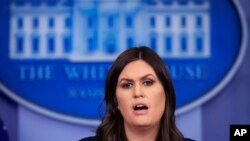 FILE - White House press secretary Sarah Huckabee Sanders talks to reporters during a press briefing in the Brady press briefing room at the White House, in Washington, Jan. 11, 2018.